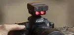If you need to remotely trigger a Canon Speedlite, one solution is to use a Speedlite Transmitter ST-E2.  Simple controls, lightweight and has two channels