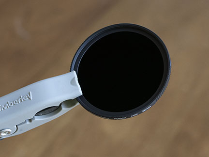 This 10 f/stop neutral density filter looks opaque, but it let in about 1/000 of the amount of light compared to with no filter. 55mm neutral density lens filter