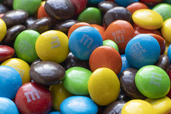 This close-up photo makes the M&M's look even more tasty. Macro photo of M&Ms
